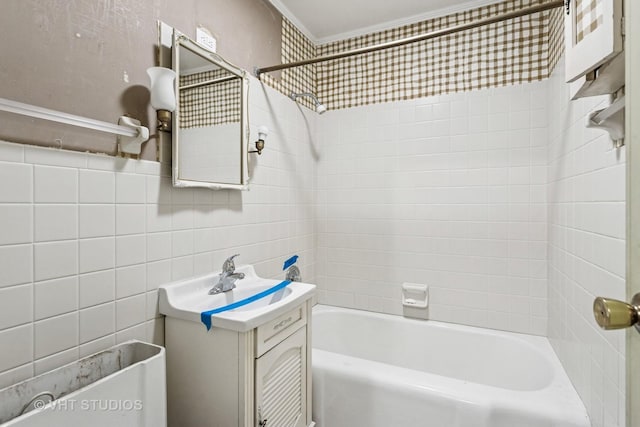 full bath with tile walls, vanity, and shower / bathing tub combination