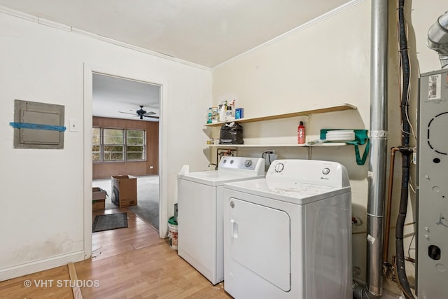 laundry area with crown molding, ceiling fan, light wood-type flooring, laundry area, and washer and dryer