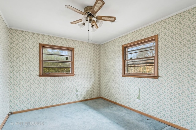 spare room with carpet, a healthy amount of sunlight, and wallpapered walls