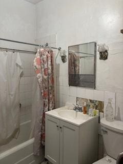 full bathroom with toilet, shower / bath combo with shower curtain, and vanity