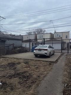 view of parking with fence