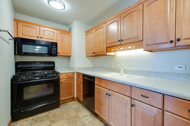 kitchen featuring light brown cabinets, black appliances, a textured ceiling, and a sink