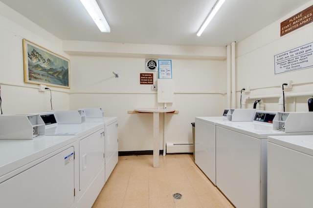 common laundry area featuring light tile patterned floors, baseboard heating, and washing machine and clothes dryer