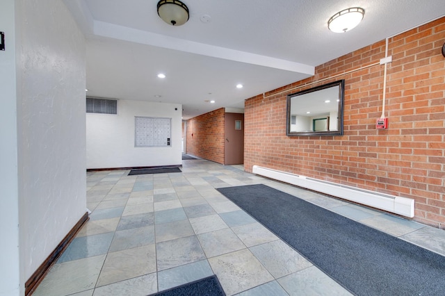 hall with visible vents, baseboards, brick wall, a baseboard radiator, and recessed lighting