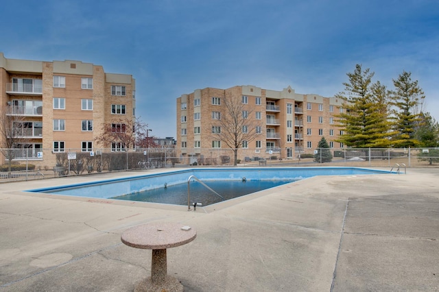 pool featuring a patio area and fence