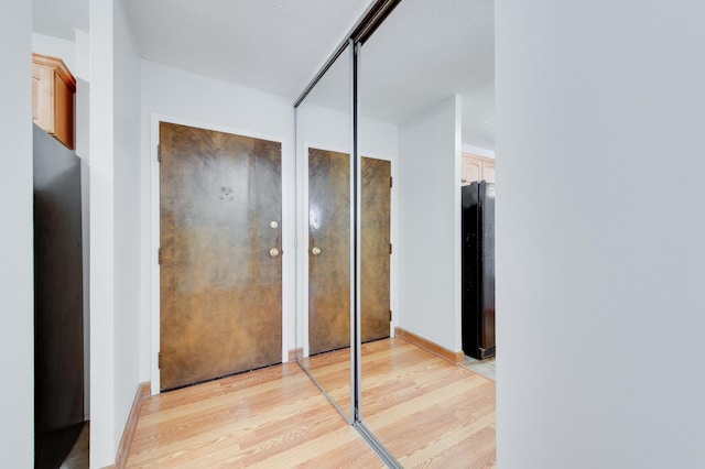 interior space with baseboards and light wood-style floors