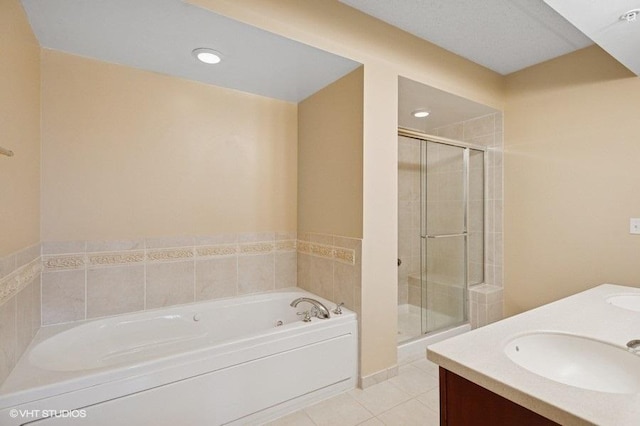 bathroom featuring a bath, a stall shower, a sink, and tile patterned floors