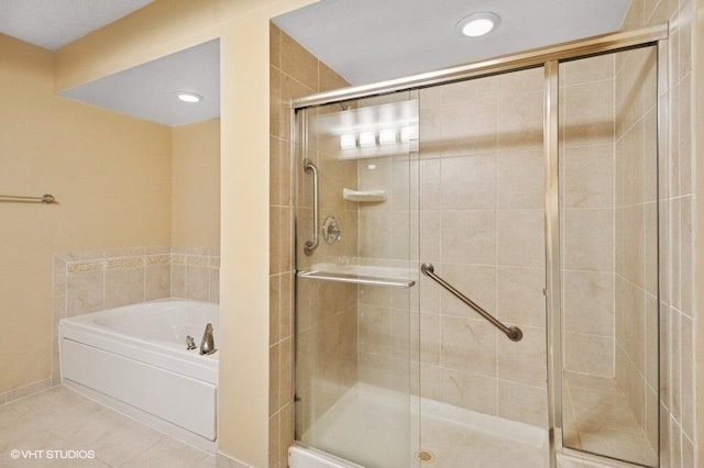 full bath with a stall shower, tile patterned flooring, a garden tub, and recessed lighting