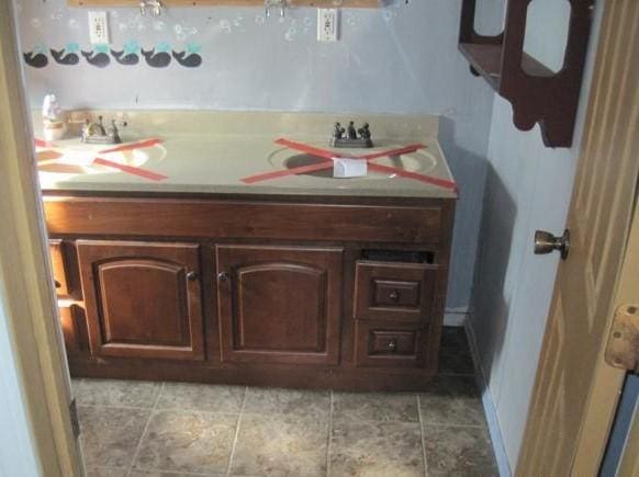 bathroom with tile patterned flooring and a sink