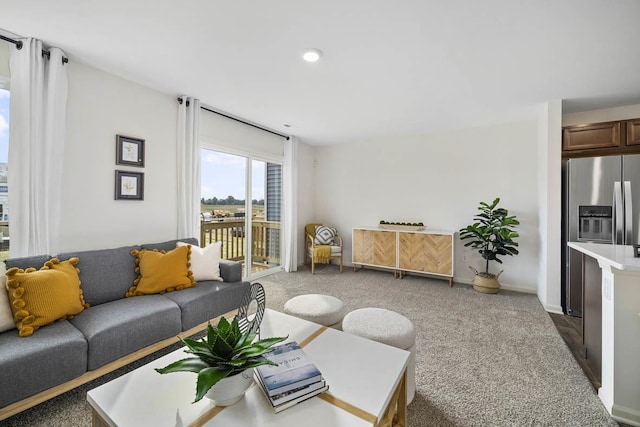 living area featuring carpet flooring and baseboards