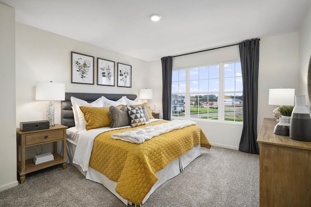 bedroom featuring carpet floors and baseboards