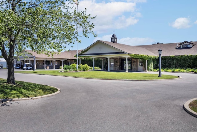 view of building exterior featuring curved driveway