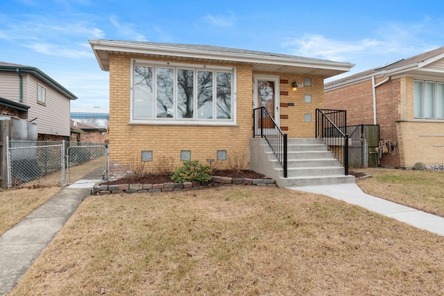 bungalow-style house with brick siding, crawl space, a front lawn, and a gate