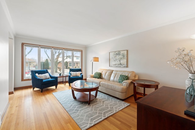 living area with baseboards, light wood-type flooring, and crown molding