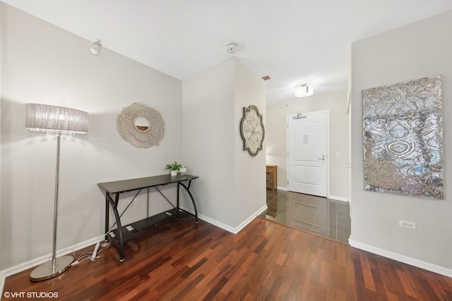 entryway featuring baseboards and wood finished floors