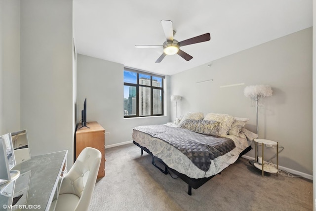 carpeted bedroom featuring a ceiling fan and baseboards