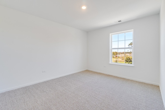 empty room featuring recessed lighting, carpet, visible vents, and baseboards