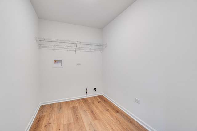 laundry room with laundry area, baseboards, gas dryer hookup, hookup for a washing machine, and light wood-style floors