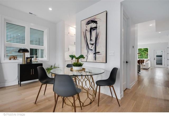 dining room featuring light wood finished floors, plenty of natural light, and recessed lighting