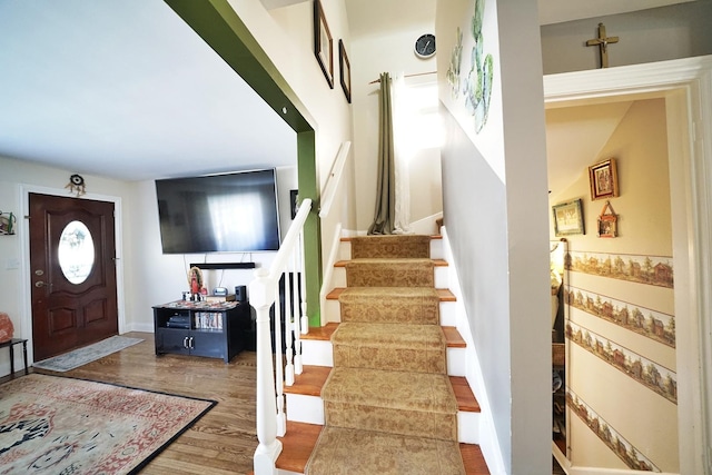 foyer entrance with stairs and wood finished floors