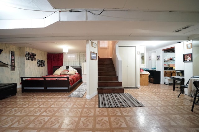 bedroom featuring light floors, visible vents, and baseboards