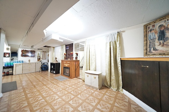 kitchen featuring light floors and a textured ceiling