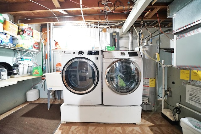 washroom with laundry area, separate washer and dryer, and gas water heater