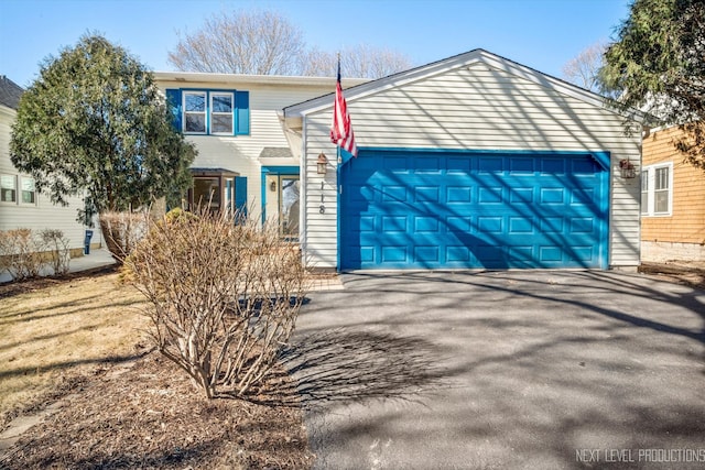 view of front facade featuring aphalt driveway and a garage