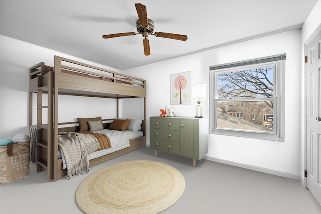 carpeted bedroom featuring a ceiling fan and baseboards