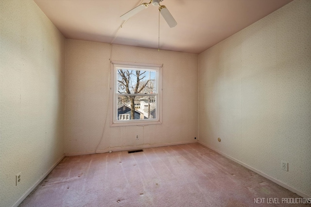 unfurnished room featuring ceiling fan, carpet flooring, and visible vents