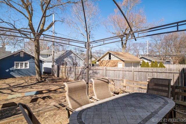 exterior space with outdoor dining area and fence