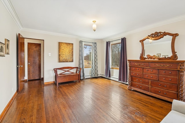 bedroom featuring ornamental molding, hardwood / wood-style floors, baseboard heating, and baseboards