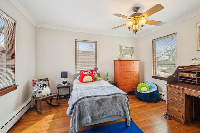 bedroom with a baseboard heating unit, multiple windows, ornamental molding, and wood finished floors