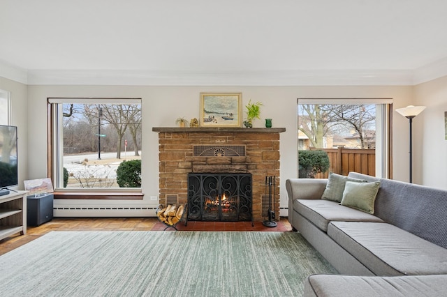 living room with ornamental molding, a stone fireplace, and baseboard heating