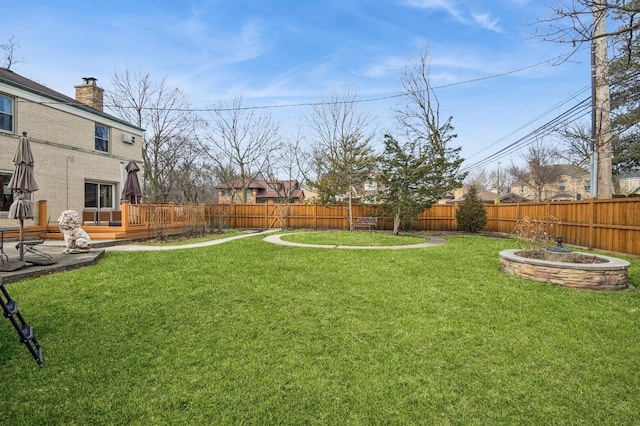 view of yard featuring a fenced backyard and a deck