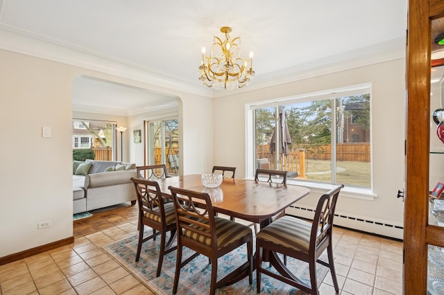 dining space with ornamental molding, arched walkways, plenty of natural light, and baseboards