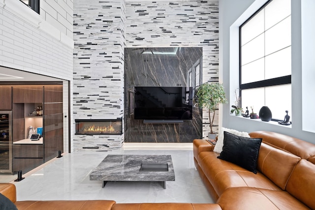 living area featuring a tiled fireplace