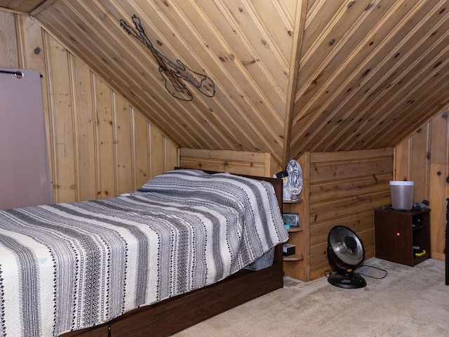 bedroom with lofted ceiling, carpet, and wooden walls