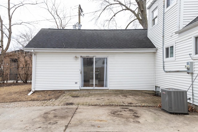 back of property featuring a patio, roof with shingles, fence, and central air condition unit