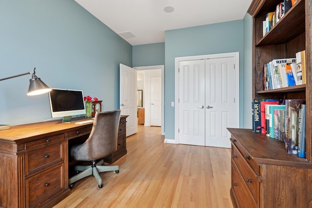 home office with baseboards, visible vents, and light wood-style floors