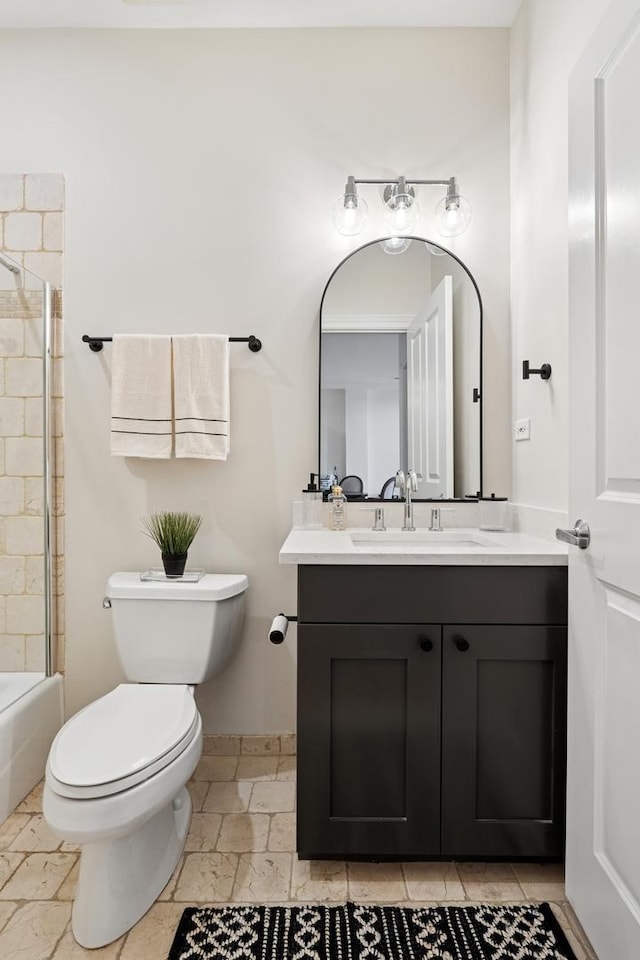 full bathroom featuring toilet, baseboards, and vanity