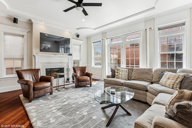 1307 W Wellington Ave, Chicago, IL 60657 - living area with ceiling fan, a tile fireplace, crown molding, wood finished floors, and baseboards