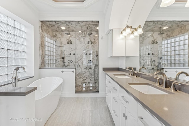 1307 W Wellington Ave, Chicago, IL 60657 - full bath with a freestanding tub, a marble finish shower, double vanity, plenty of natural light, and ornamental molding