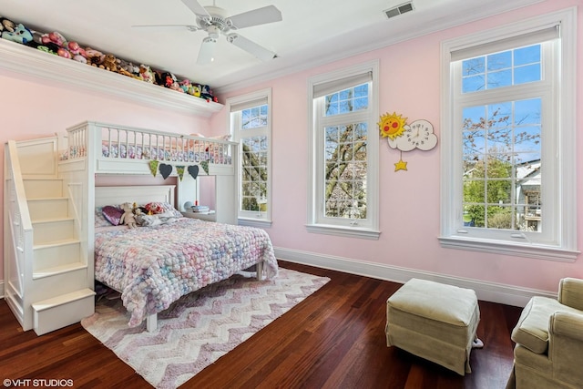 1307 W Wellington Ave, Chicago, IL 60657 - bedroom with multiple windows, dark wood-style flooring, baseboards, ornamental molding, and a ceiling fan