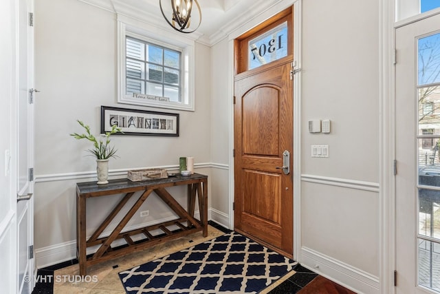 1307 W Wellington Ave, Chicago, IL 60657 - foyer with crown molding, a chandelier, and baseboards