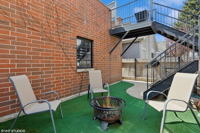 1307 W Wellington Ave, Chicago, IL 60657 - view of patio featuring stairs, an outdoor fire pit, and a balcony