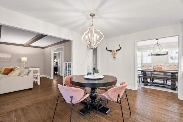 dining room featuring wood finished floors, baseboards, and an inviting chandelier