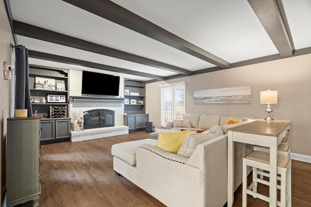 living room featuring a brick fireplace, baseboards, beam ceiling, and wood finished floors