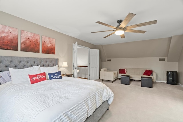 carpeted bedroom with visible vents, vaulted ceiling, baseboards, and ceiling fan