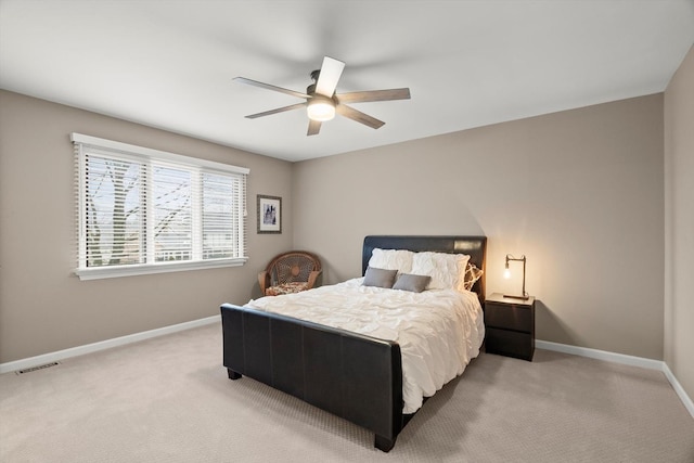 bedroom with a ceiling fan, carpet flooring, visible vents, and baseboards